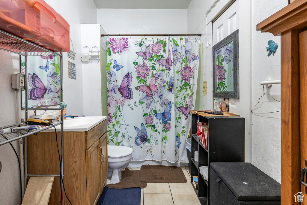 Full bathroom with vanity, tile patterned floors, and shower / tub combo with curtain