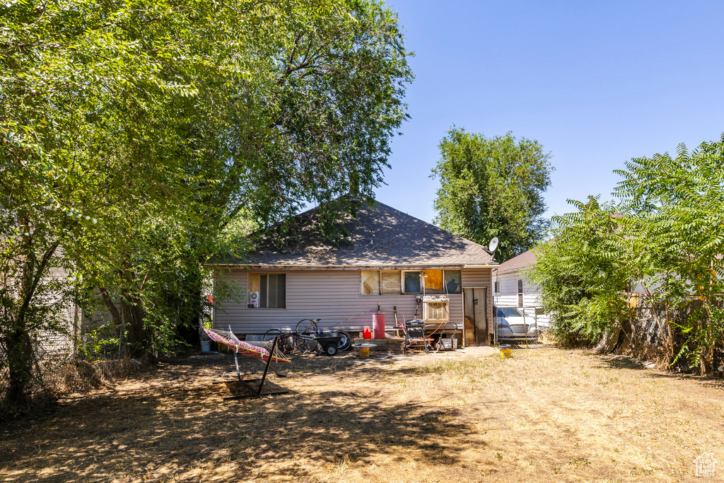 Back of house with roof with shingles