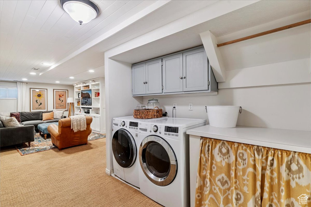 Laundry area with separate washer and dryer, light carpet, and recessed lighting