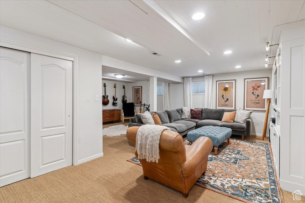 Living area with recessed lighting and light carpet