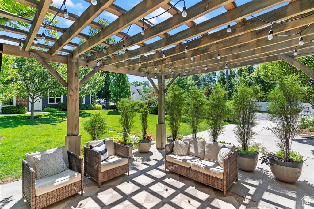 View of patio with an outdoor hangout area and a pergola