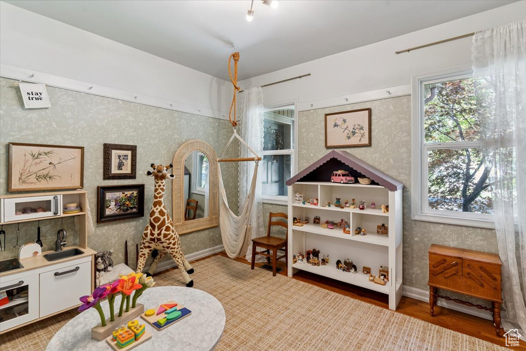 Rec room featuring wallpapered walls and wood finished floors