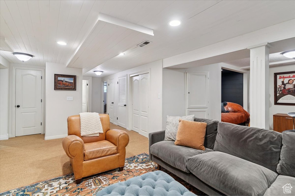 Living room with light carpet and recessed lighting