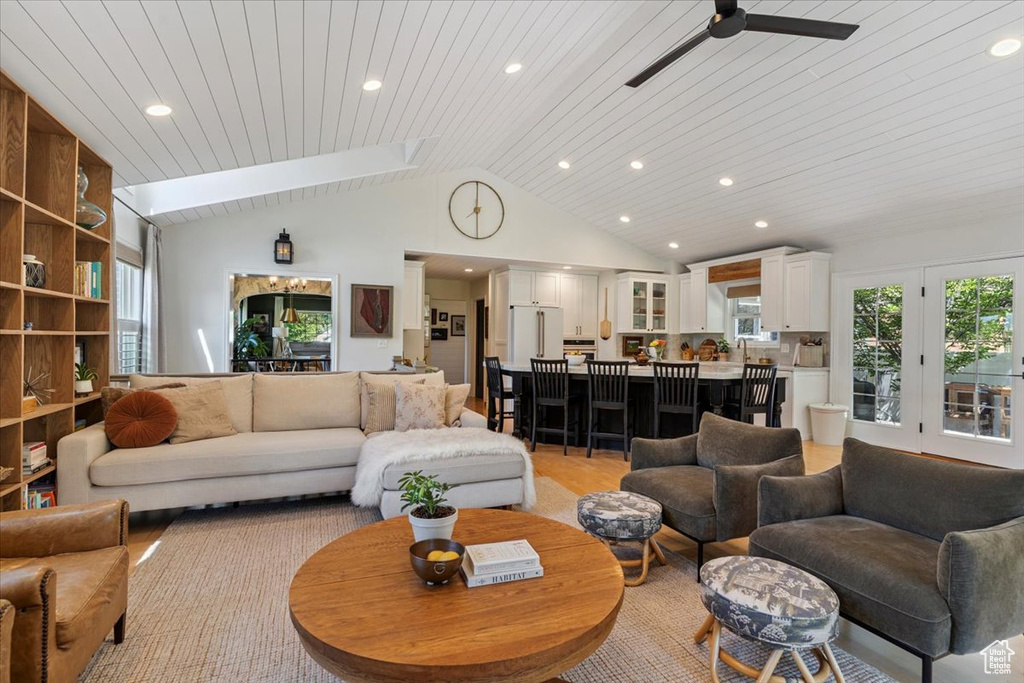 Living area featuring vaulted ceiling, a ceiling fan, and recessed lighting