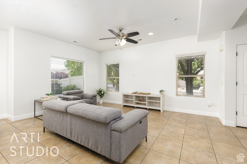 Living area featuring light tile patterned floors, ceiling fan, and recessed lighting
