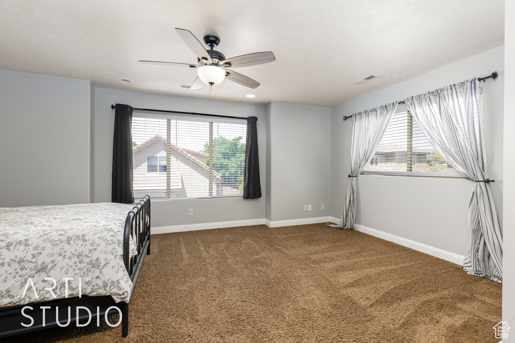 Bedroom with carpet and ceiling fan
