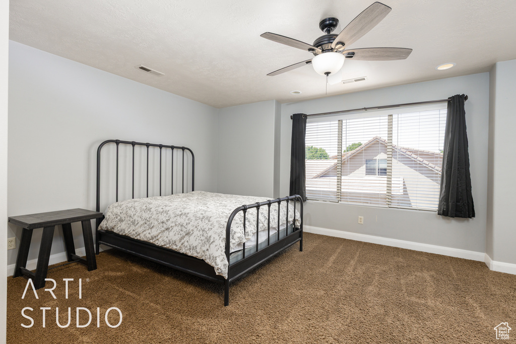 Carpeted bedroom featuring a ceiling fan and recessed lighting