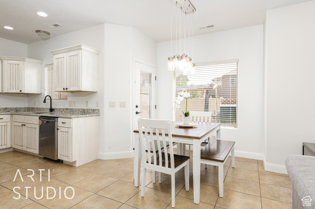 Dining area featuring light tile patterned floors, a chandelier, and recessed lighting