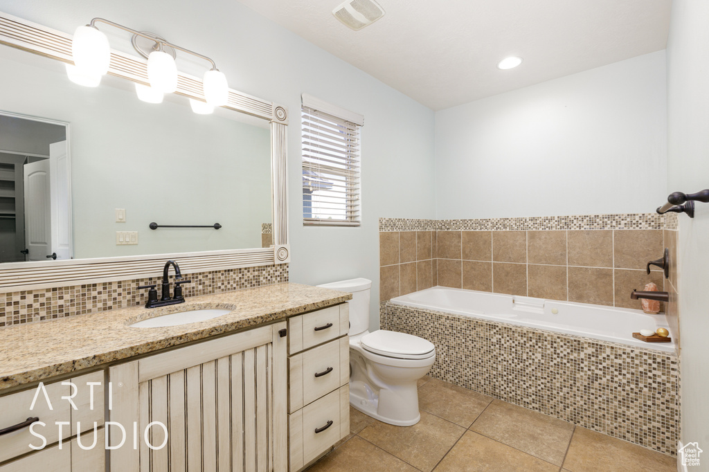 Full bathroom featuring tile patterned floors, a bath, vanity, and backsplash