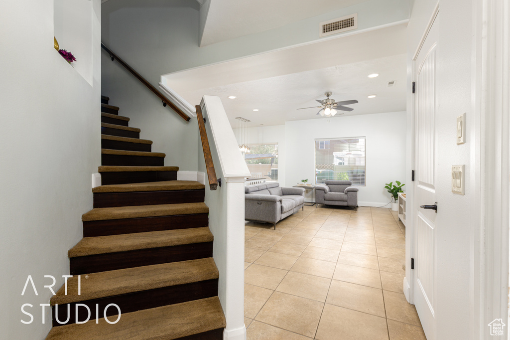 Staircase featuring tile patterned floors, ceiling fan, and recessed lighting