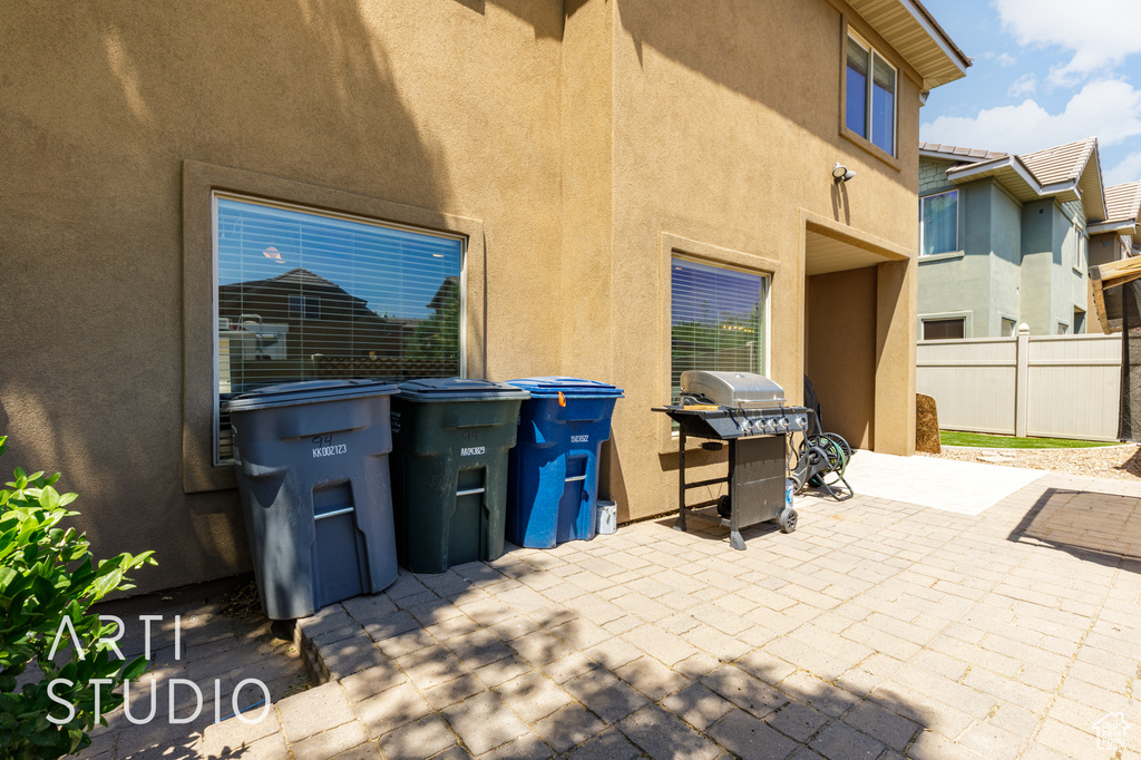 View of patio with a grill