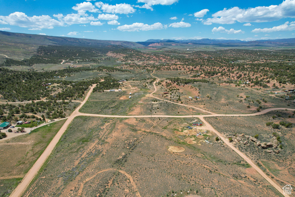 Aerial overview of property's location with a mountainous background and rural landscape