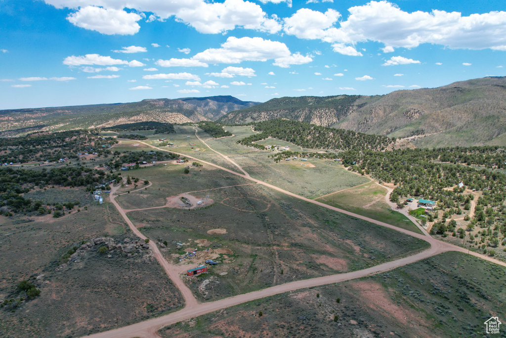 Aerial overview of property's location featuring a mountain backdrop and rural landscape