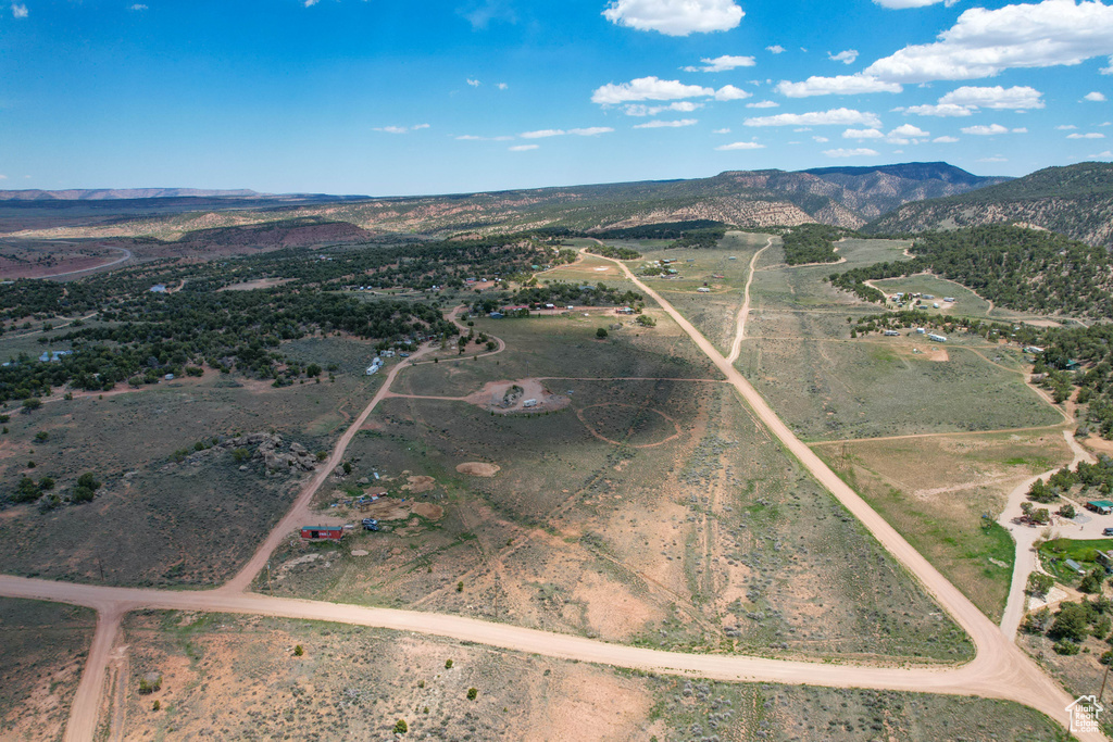 Aerial view of property's location featuring a mountain backdrop and rural landscape