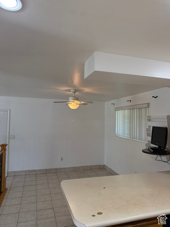 Kitchen with a ceiling fan and light tile patterned floors