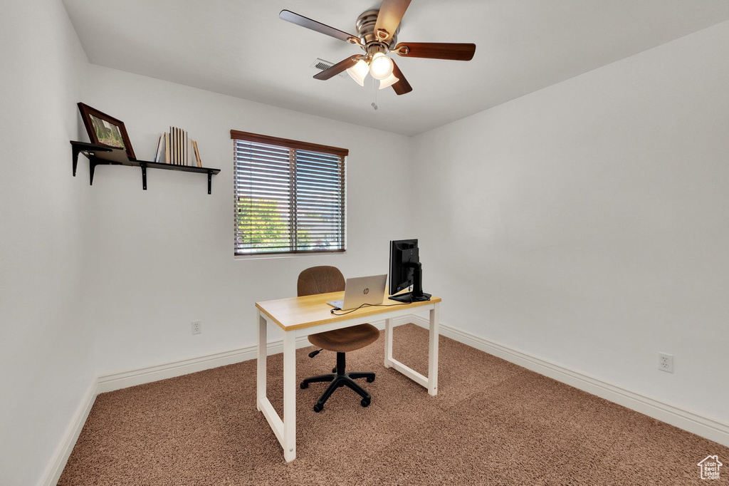 Carpeted office featuring baseboards and ceiling fan