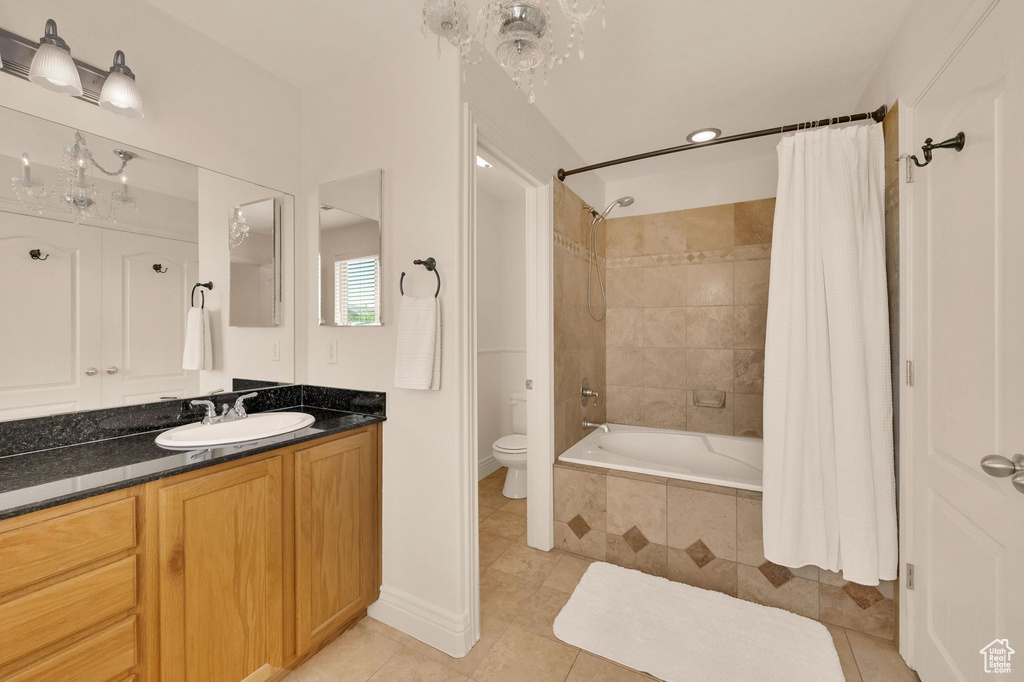 Full bathroom featuring tile patterned floors, tiled shower / bath, and vanity
