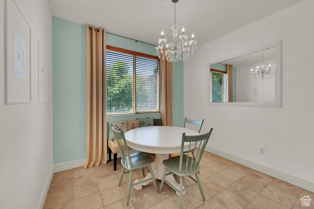 Dining space featuring a chandelier and baseboards