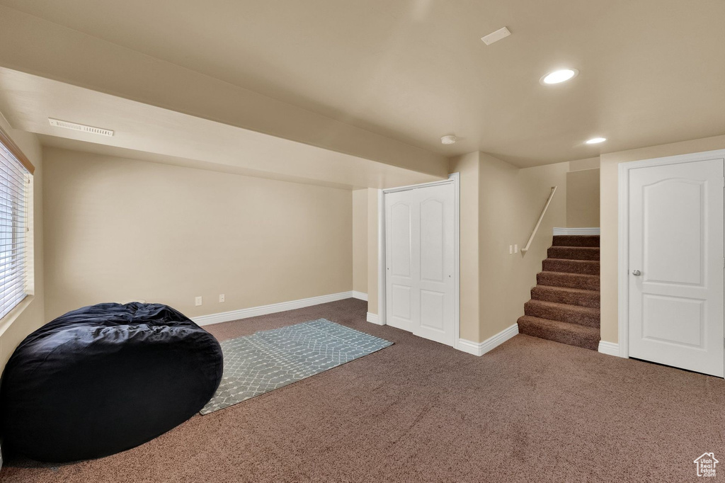 Sitting room featuring carpet, stairs, and recessed lighting
