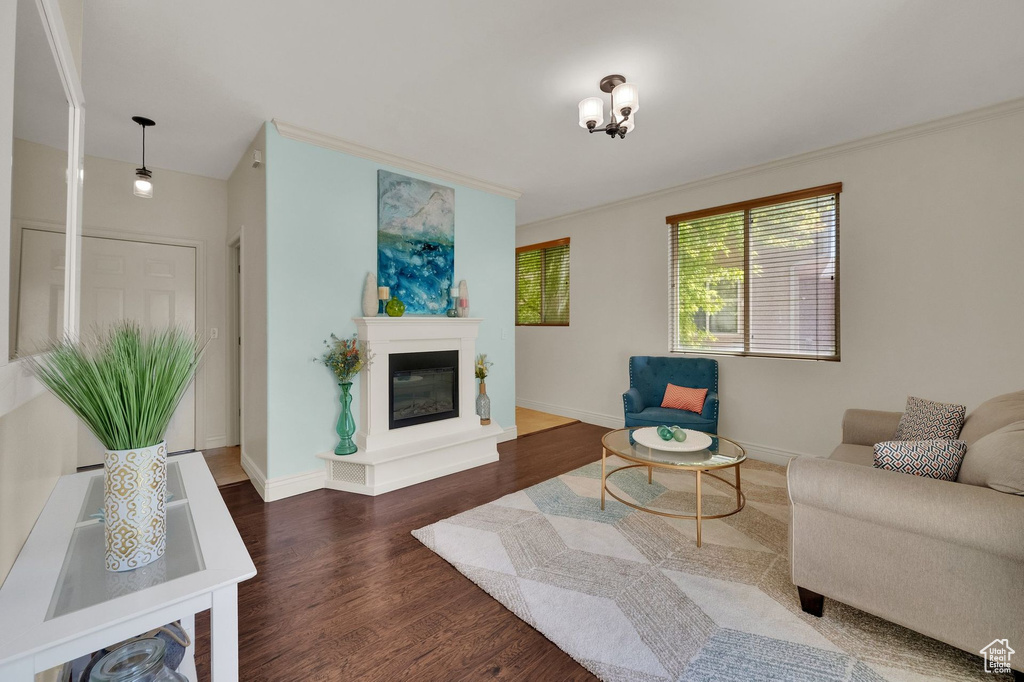 Living area featuring wood finished floors and a glass covered fireplace