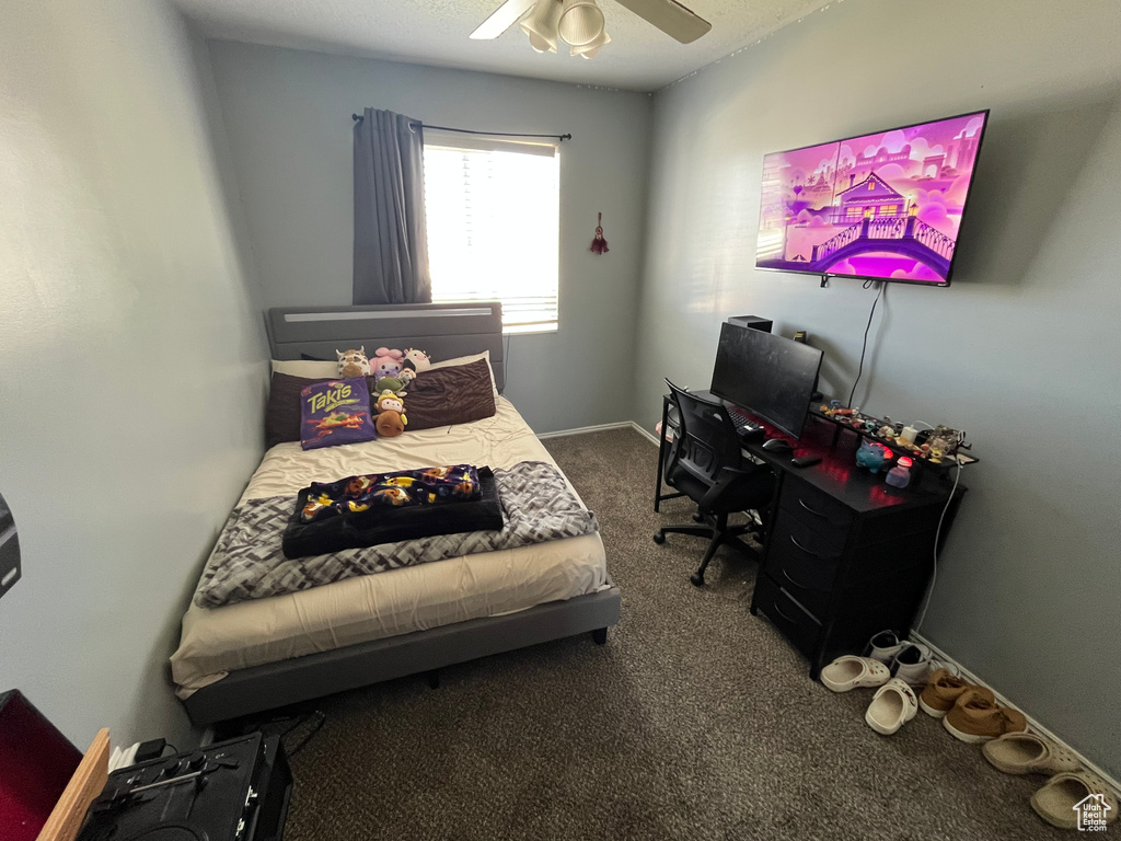 Bedroom featuring carpet floors, a ceiling fan, and a desk