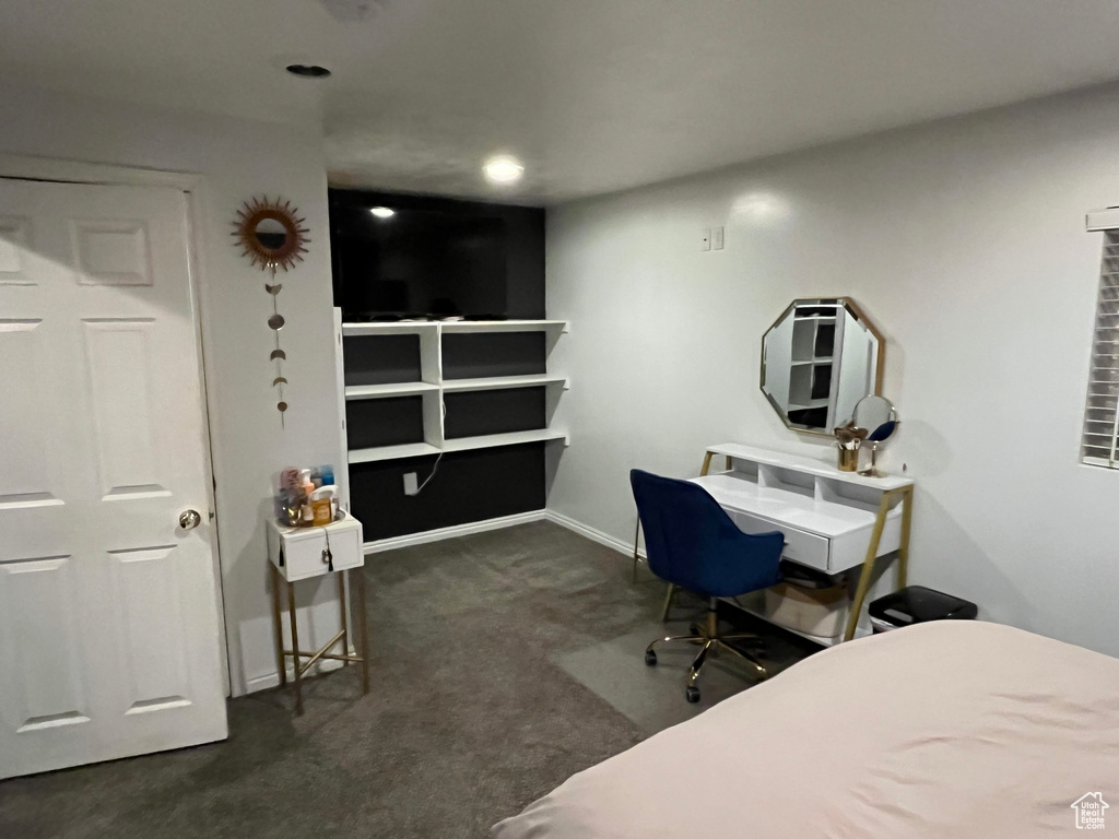 Carpeted bedroom featuring baseboards