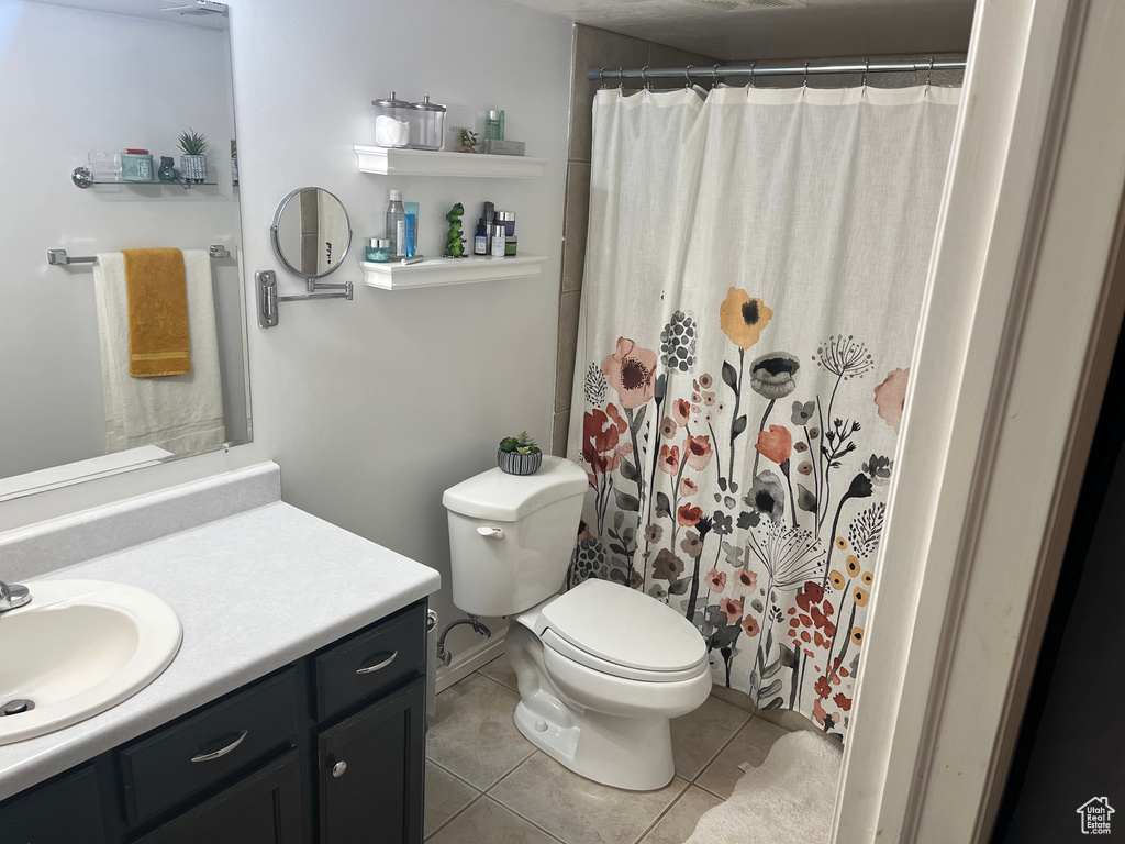 Full bath featuring vanity, tile patterned floors, and a shower with curtain