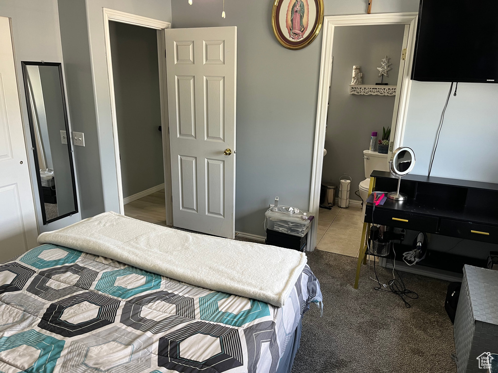 Bedroom featuring carpet flooring and ensuite bath
