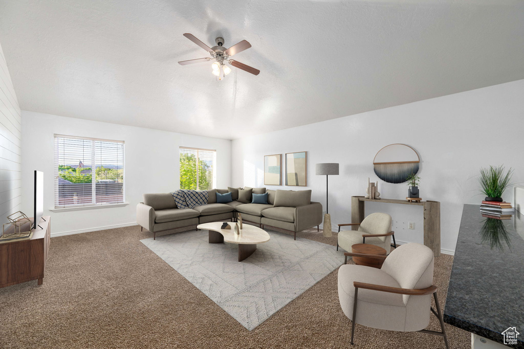 Living room featuring carpet flooring and ceiling fan