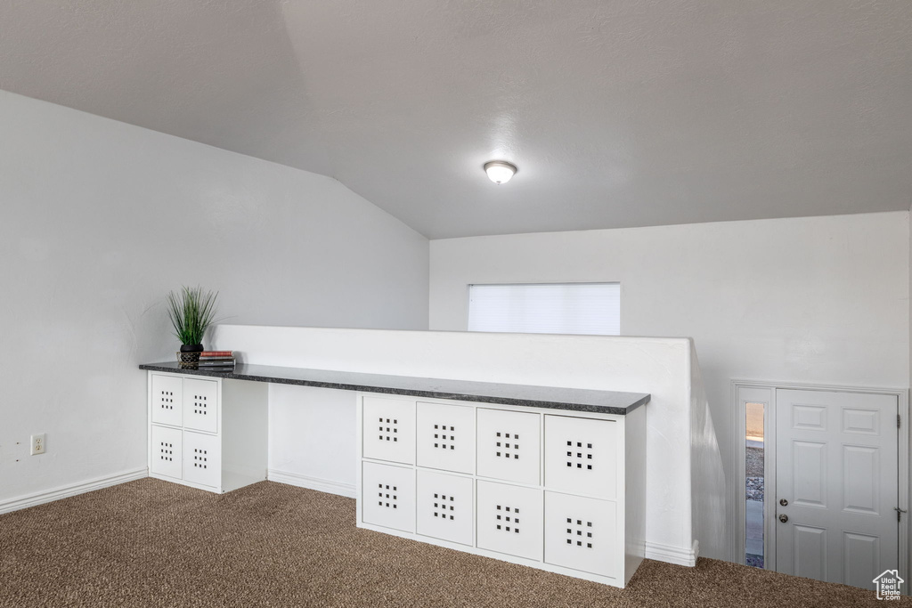 Detailed view of carpet flooring and baseboards