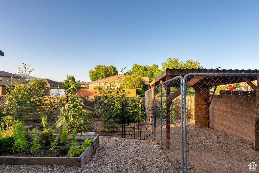 View of yard with a garden and a gate