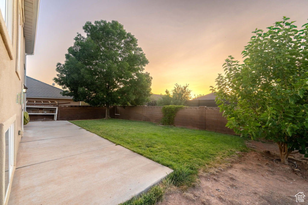 Fenced backyard with a patio