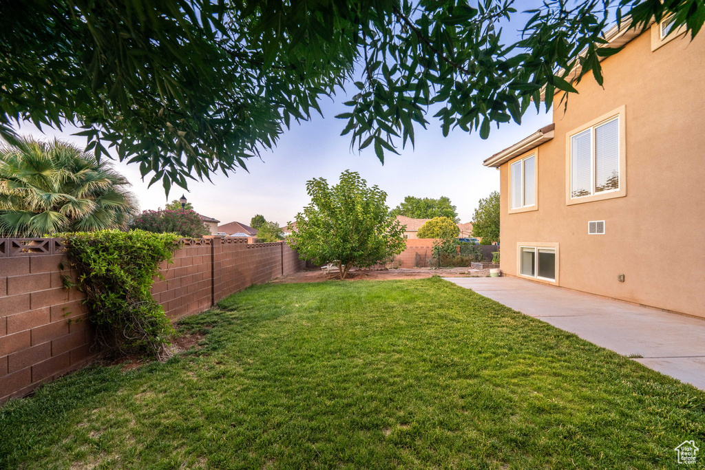 Fenced backyard featuring a patio