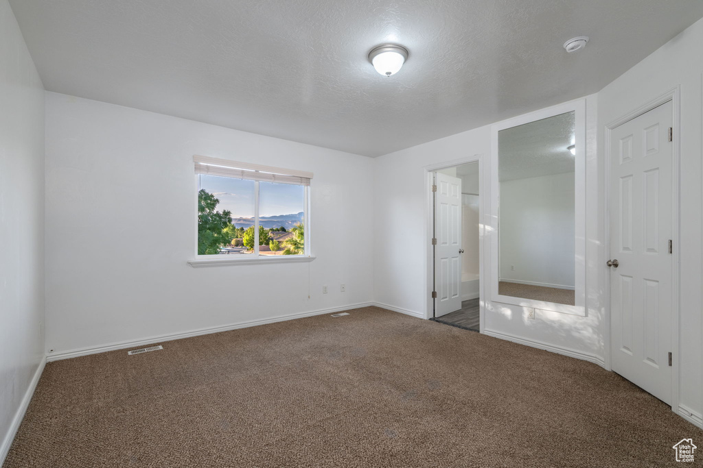 Unfurnished bedroom with carpet flooring