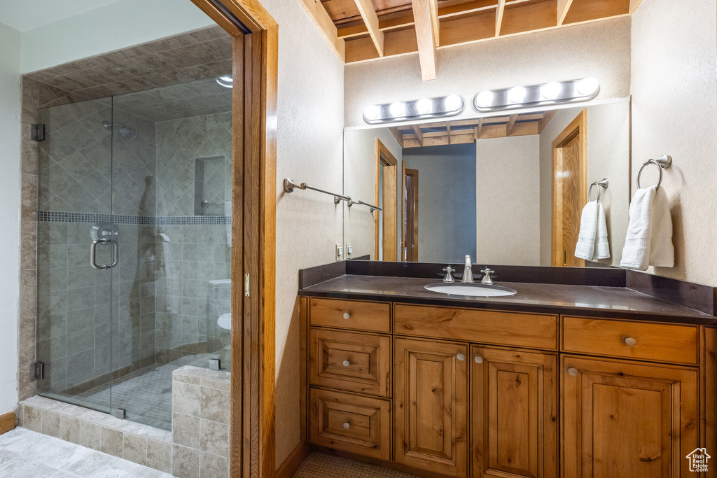 Bathroom with vanity and a stall shower