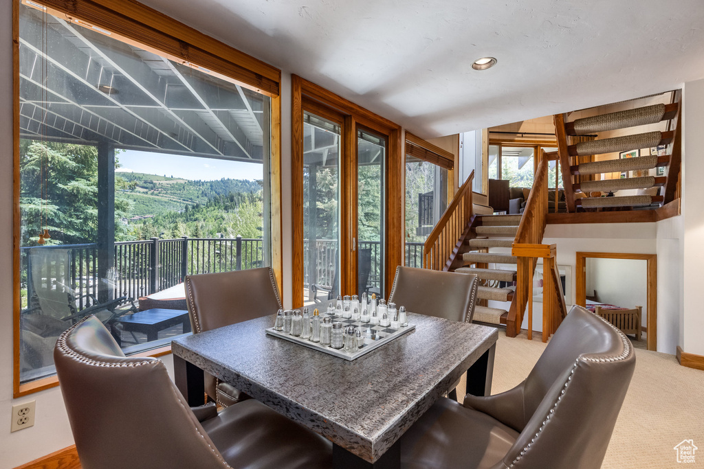 Dining room with stairs, carpet flooring, and recessed lighting