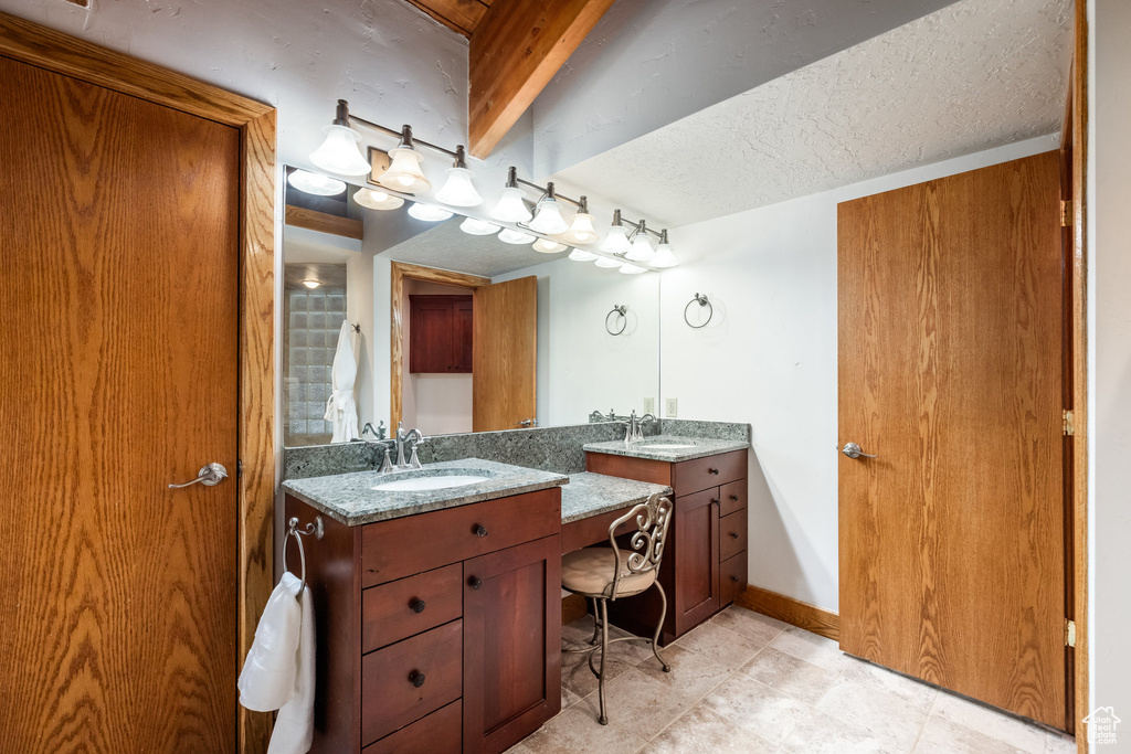 Bathroom featuring vanity and a textured ceiling