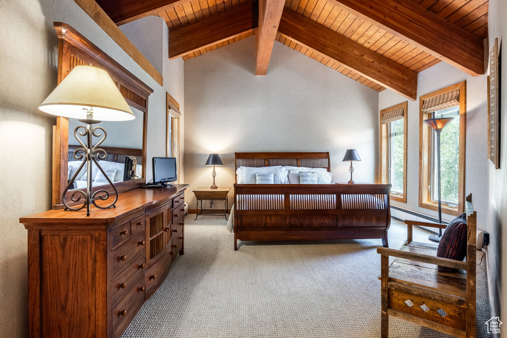 Carpeted bedroom featuring wooden ceiling and baseboard heating