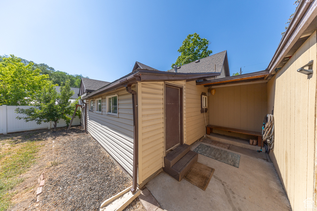 Property entrance with a shingled roof