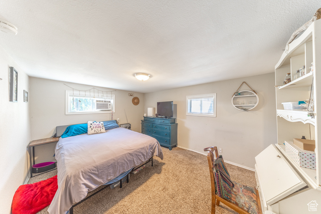 Bedroom featuring carpet flooring and baseboards