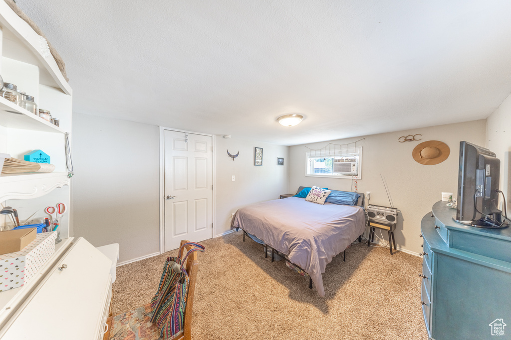 Bedroom featuring light carpet