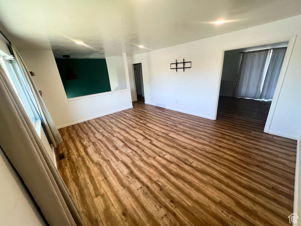 Spare room featuring wood finished floors and baseboards