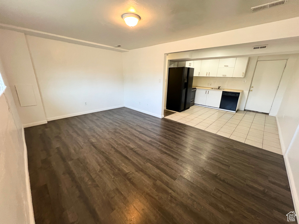 Unfurnished living room with wood finished floors and baseboards