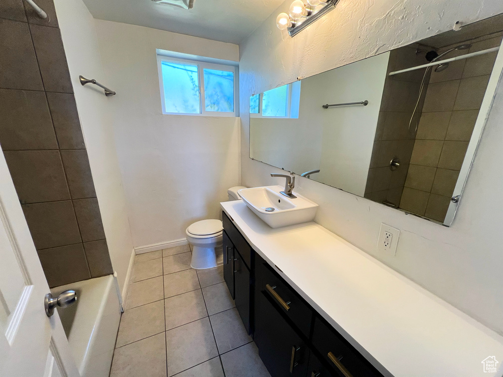 Full bathroom featuring vanity, tile patterned floors, and tub / shower combination