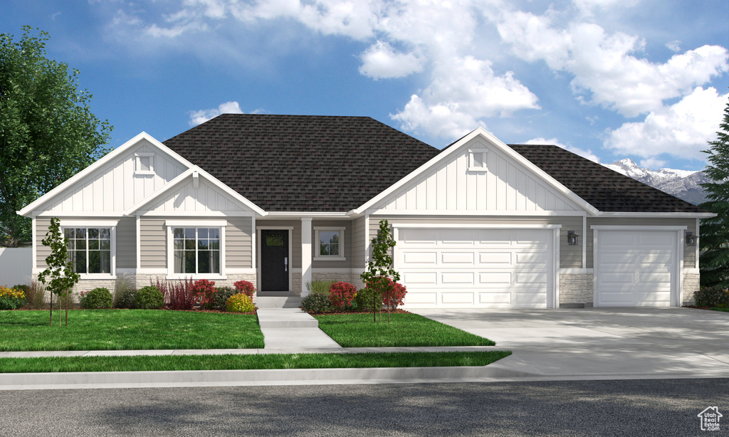 Craftsman house featuring board and batten siding, stone siding, an attached garage, a front lawn, and roof with shingles