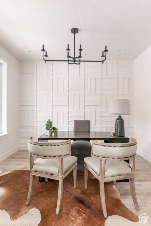 Living area featuring a chandelier, light wood-type flooring, and recessed lighting