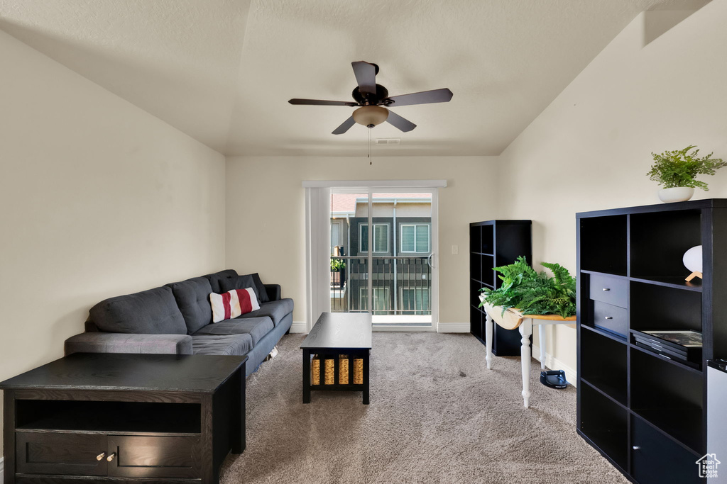 Living area with carpet flooring and ceiling fan