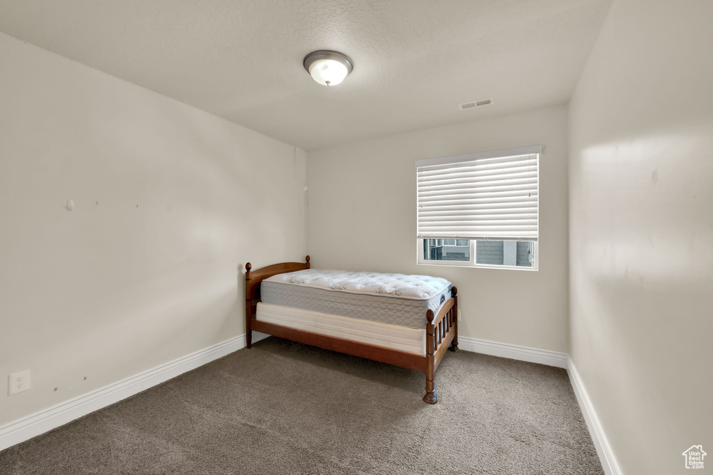 Carpeted bedroom with baseboards