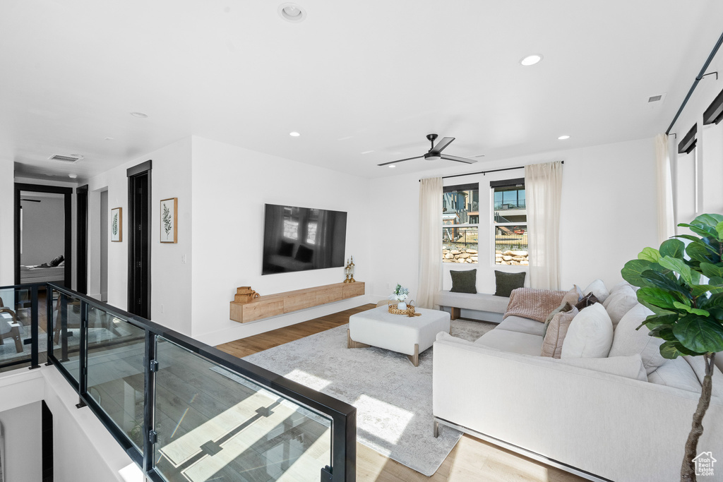 Living area featuring wood finished floors, recessed lighting, and ceiling fan