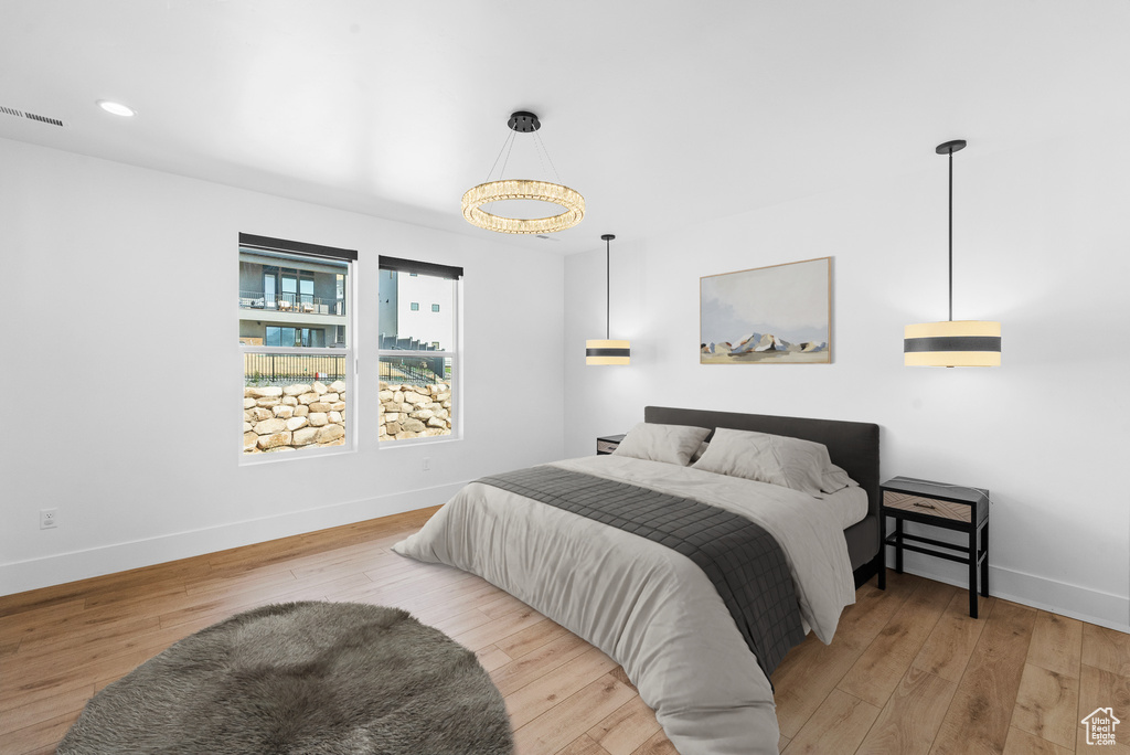 Bedroom with wood finished floors and recessed lighting